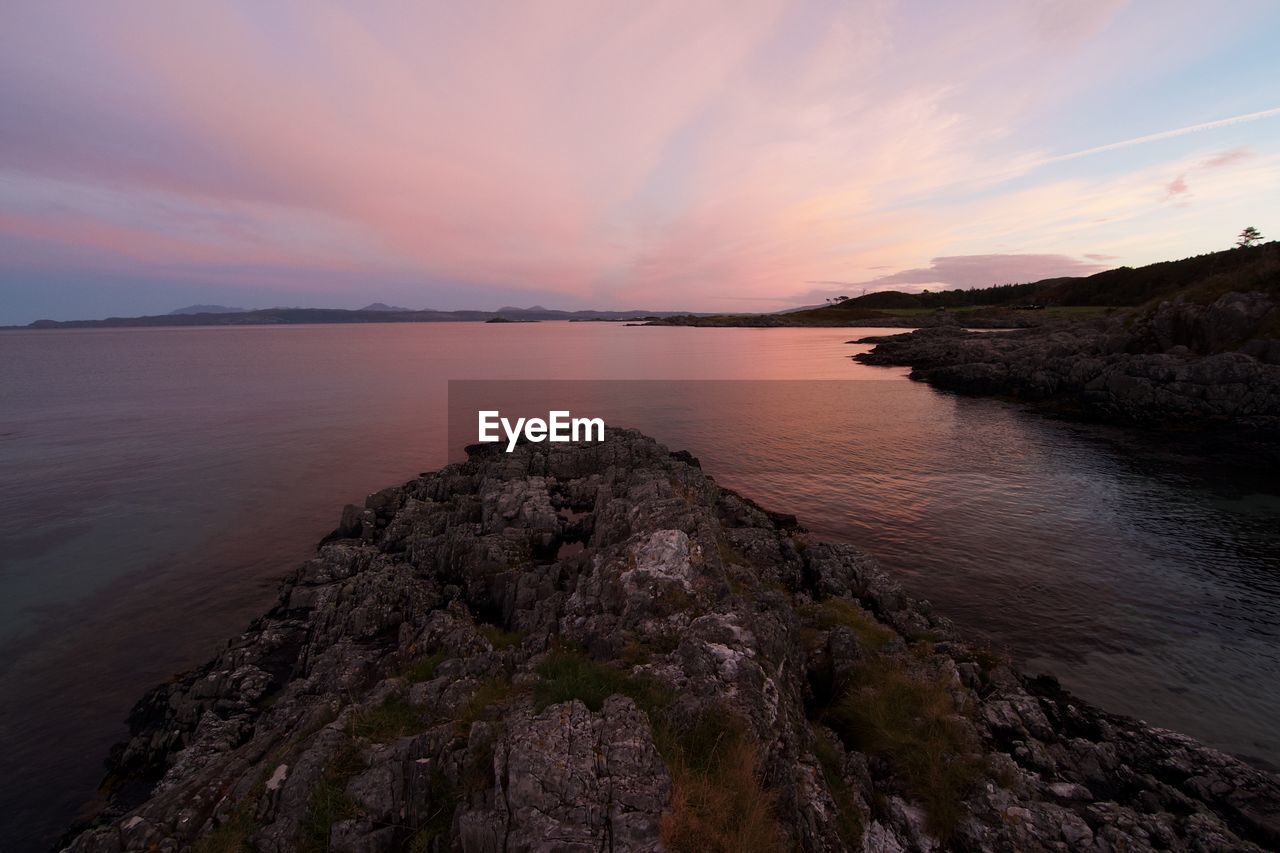 Scenic view of river against sky during sunset