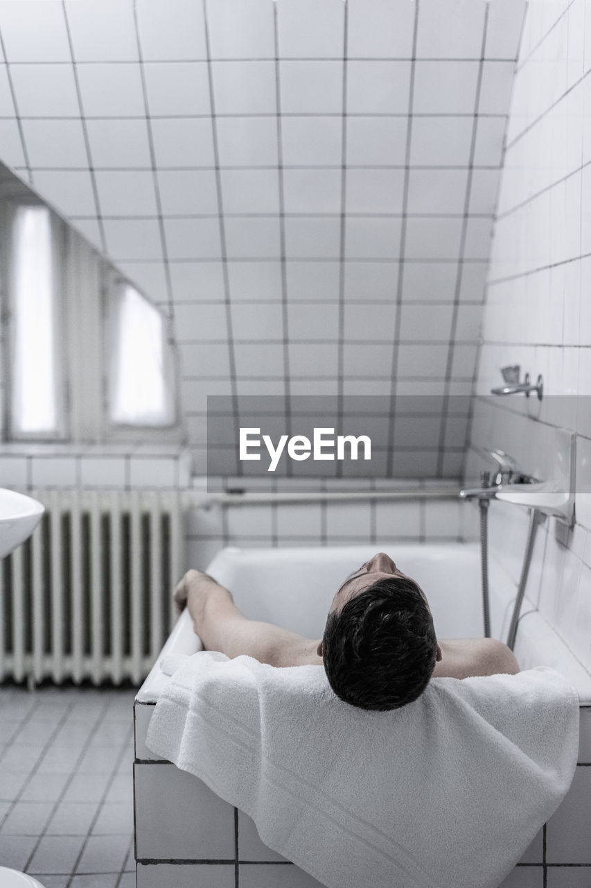 Man resting in bathtub