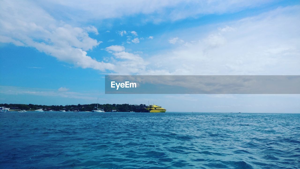 SHIP IN SEA AGAINST SKY