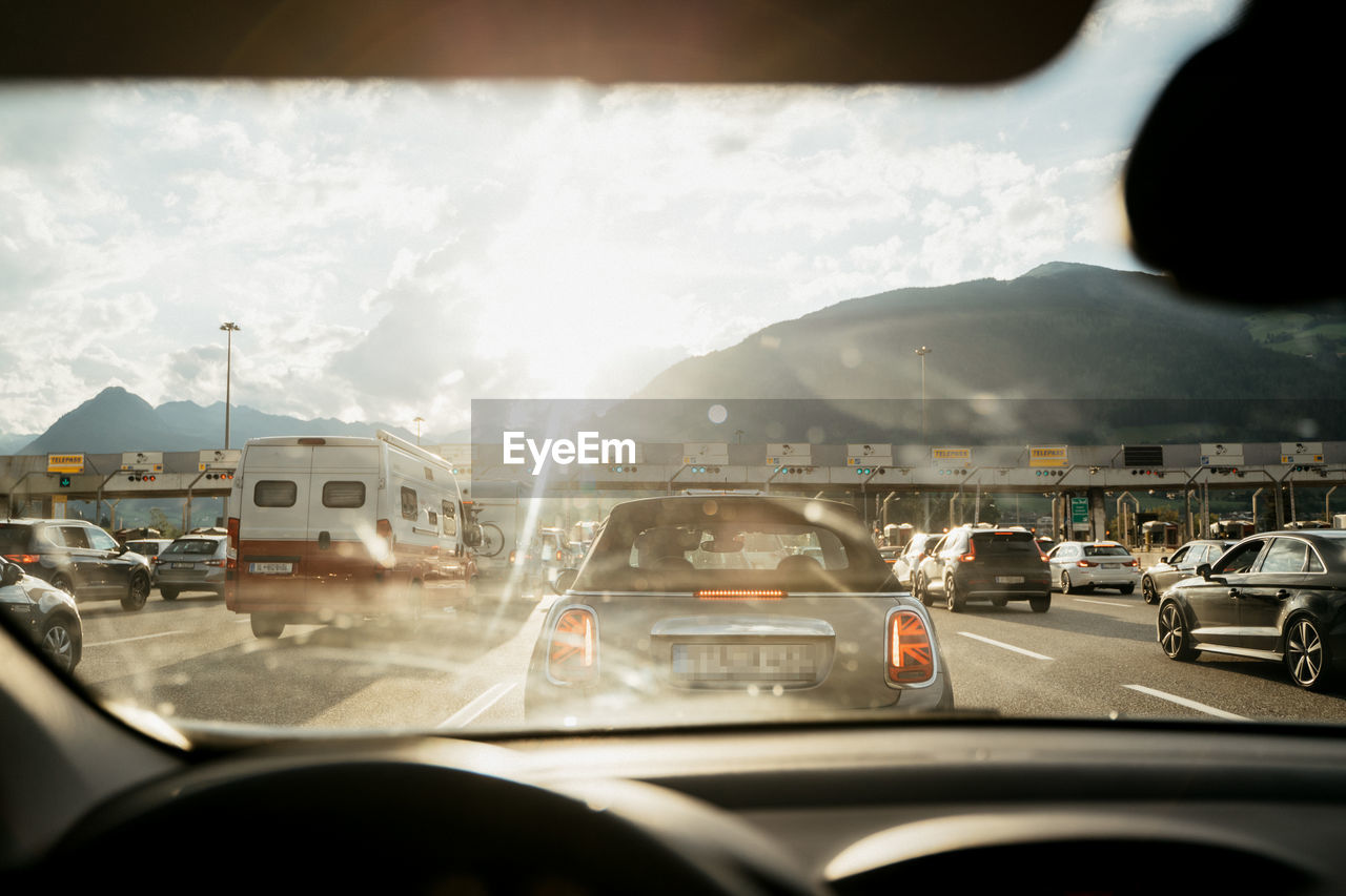 TRAFFIC ON ROAD IN CITY SEEN THROUGH CAR