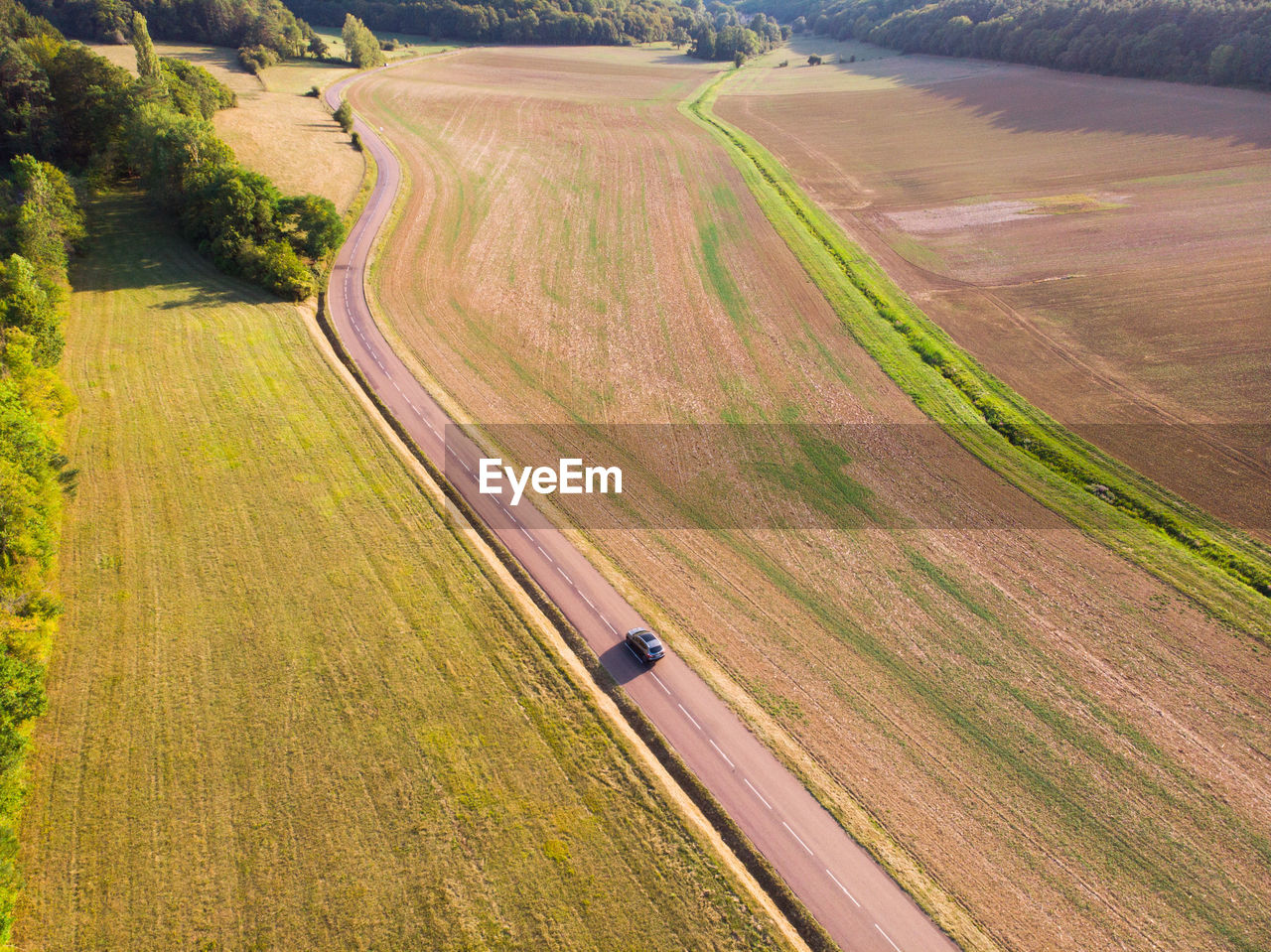 High angle view of agricultural field. aerial view of road. aerial view of a car on the road 