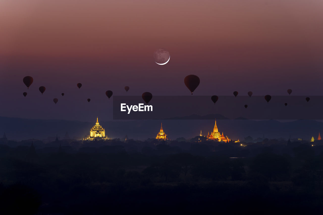 Hot air balloons against sky during sunset