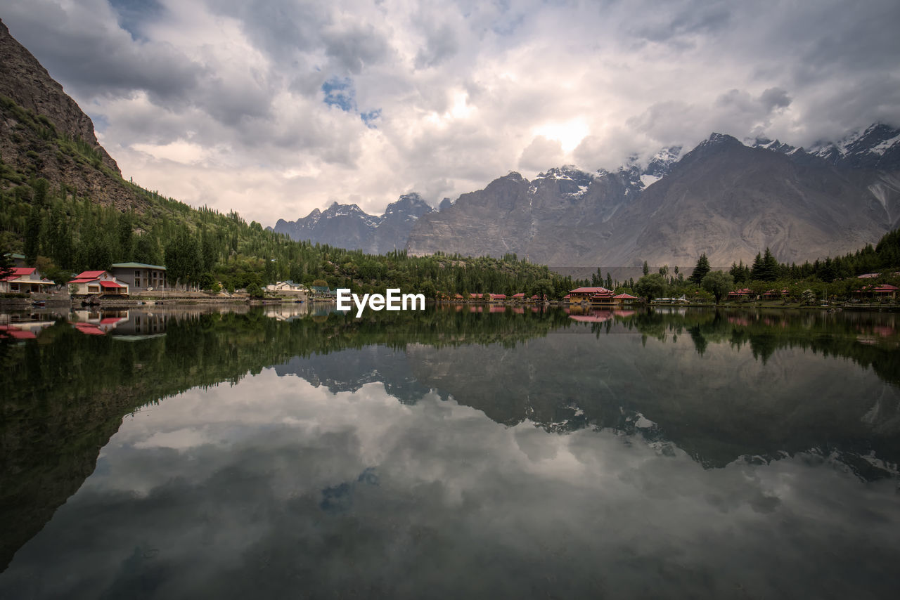 Scenic view of lake and mountains against sky