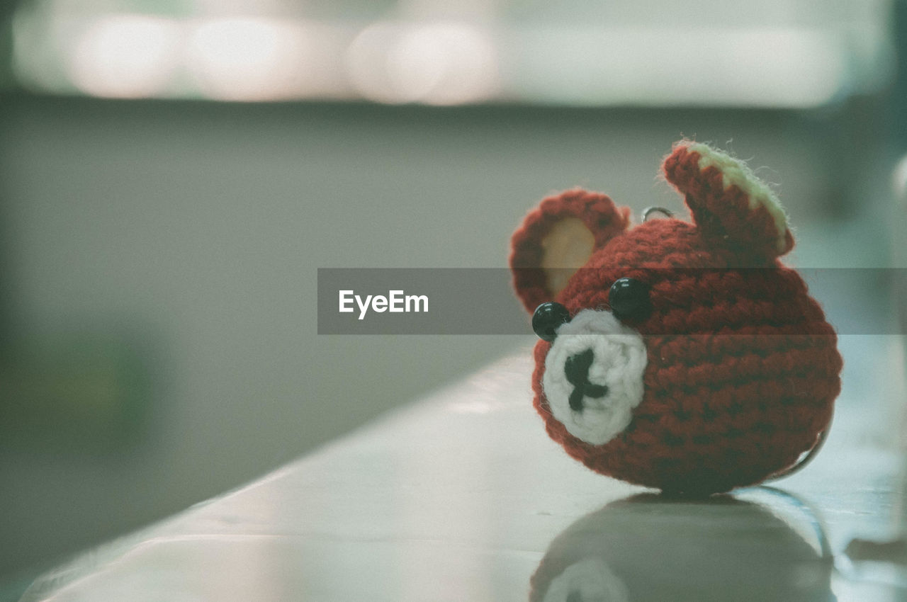 Close-up of knitted teddy bear on table