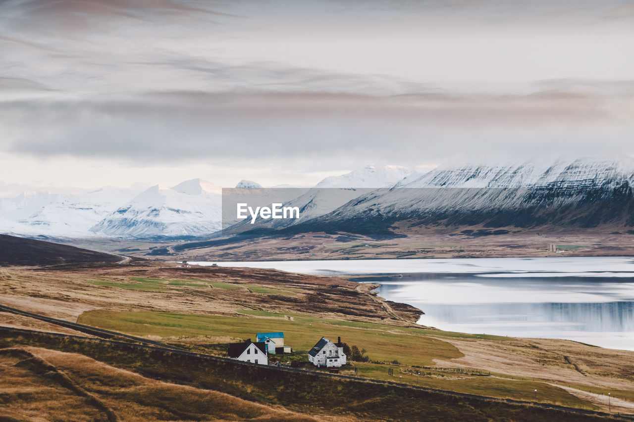 HIGH ANGLE VIEW OF SNOWCAPPED MOUNTAINS AGAINST SKY