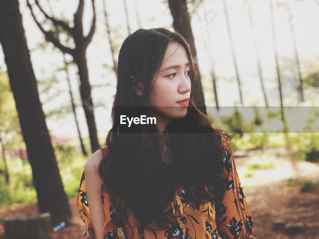 Young woman looking away outdoors