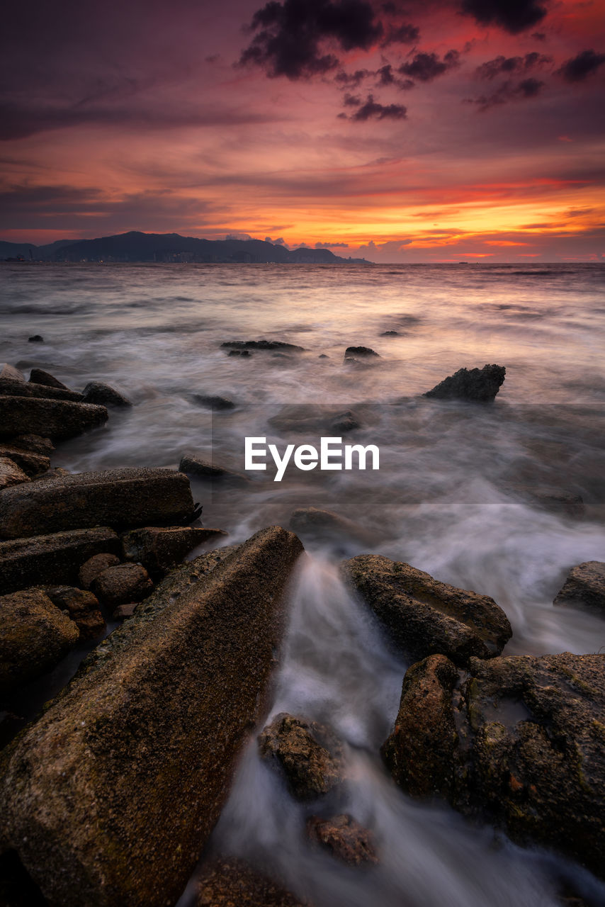 sea, water, sky, land, sunset, beauty in nature, scenics - nature, beach, cloud, motion, rock, nature, coast, ocean, wave, environment, shore, wind wave, body of water, dawn, long exposure, horizon, evening, horizon over water, seascape, travel destinations, no people, landscape, dramatic sky, outdoors, water sports, tranquility, sports, sun, coastline, idyllic, travel, tranquil scene, sunlight, reflection, tourism