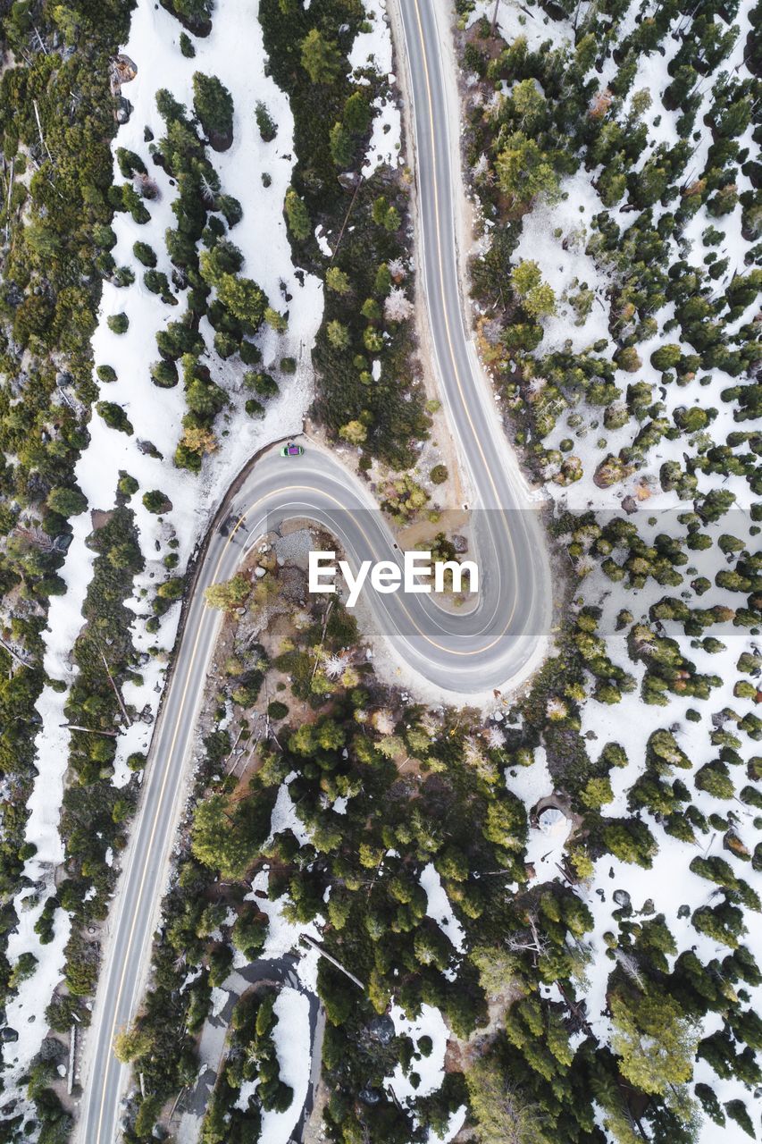 Aerial view of winding road in forest during winter