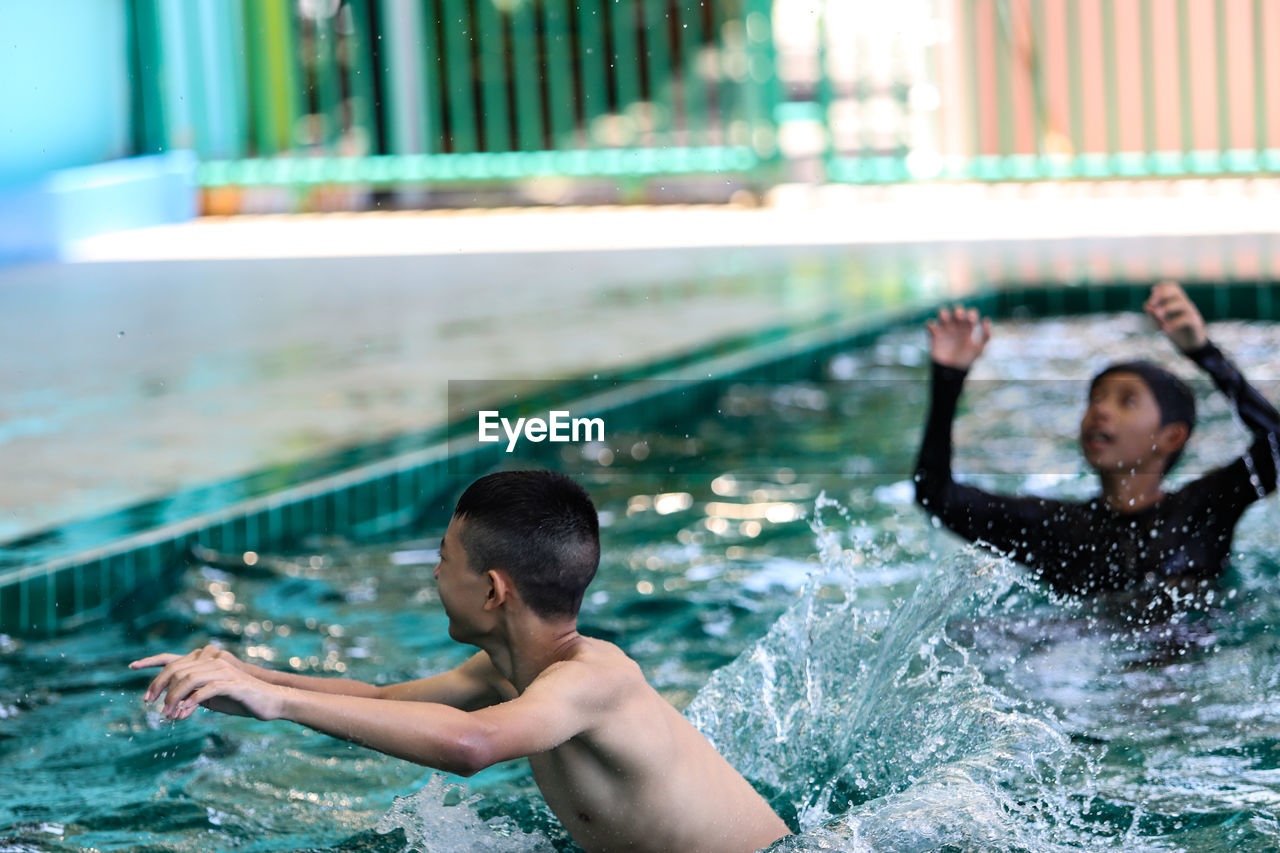 Young man swimming in pool