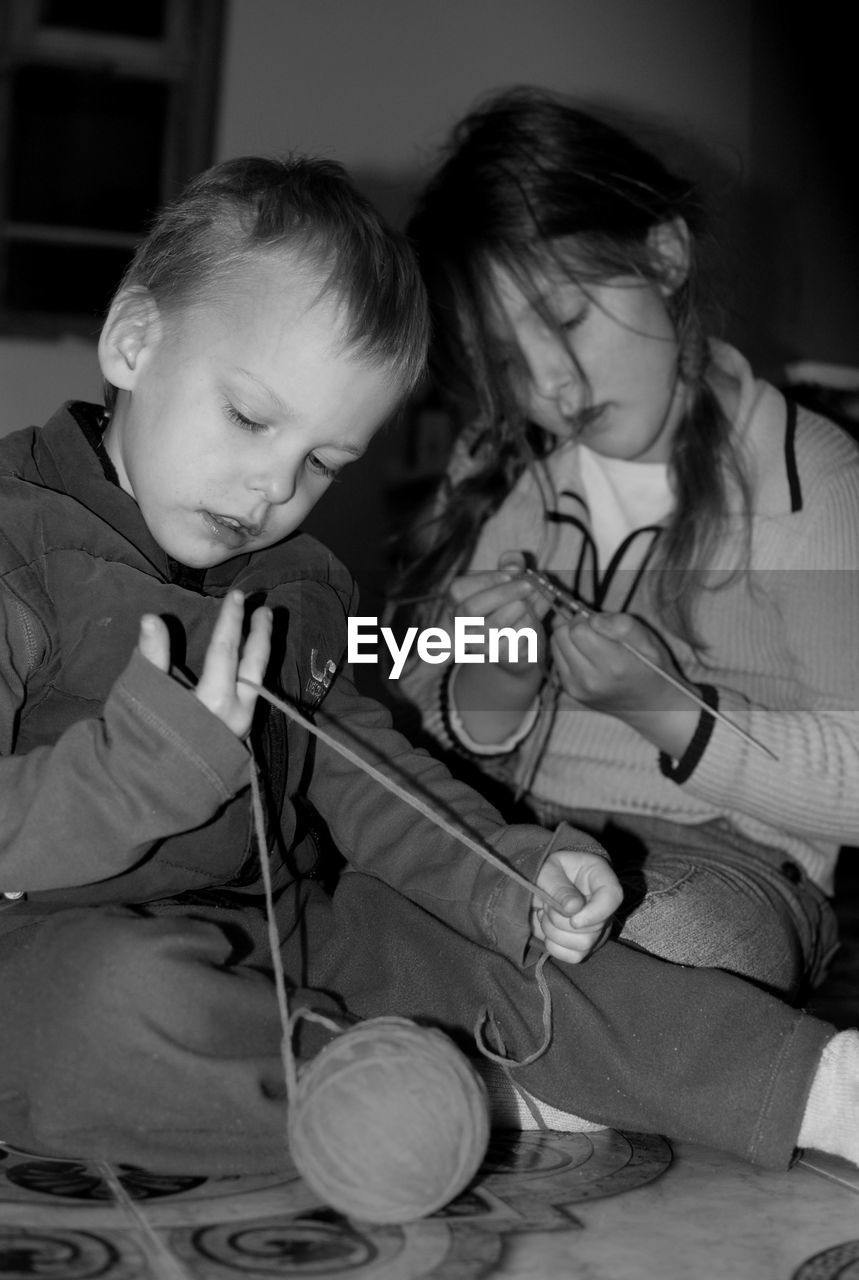 Siblings knitting at home