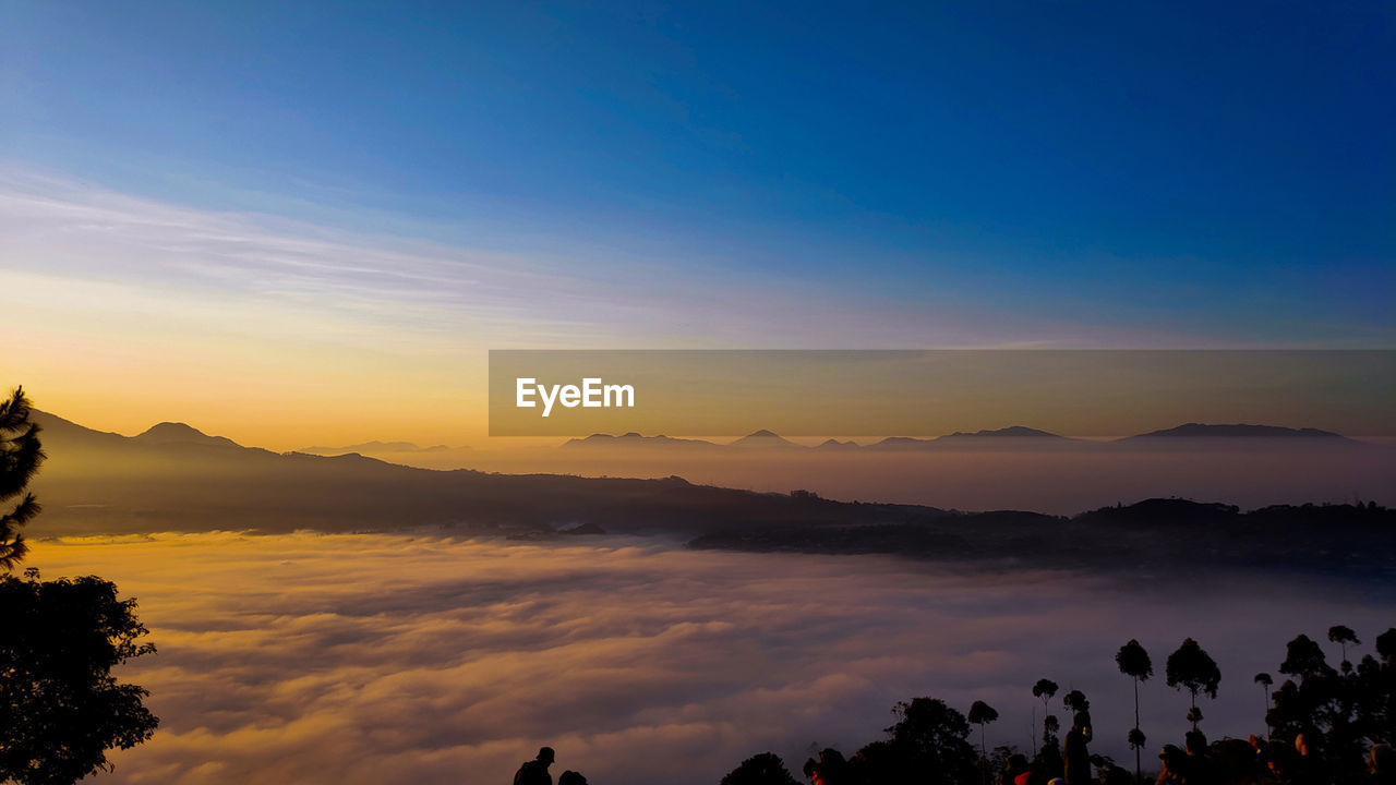 Scenic view of silhouette mountains against sky during sunset