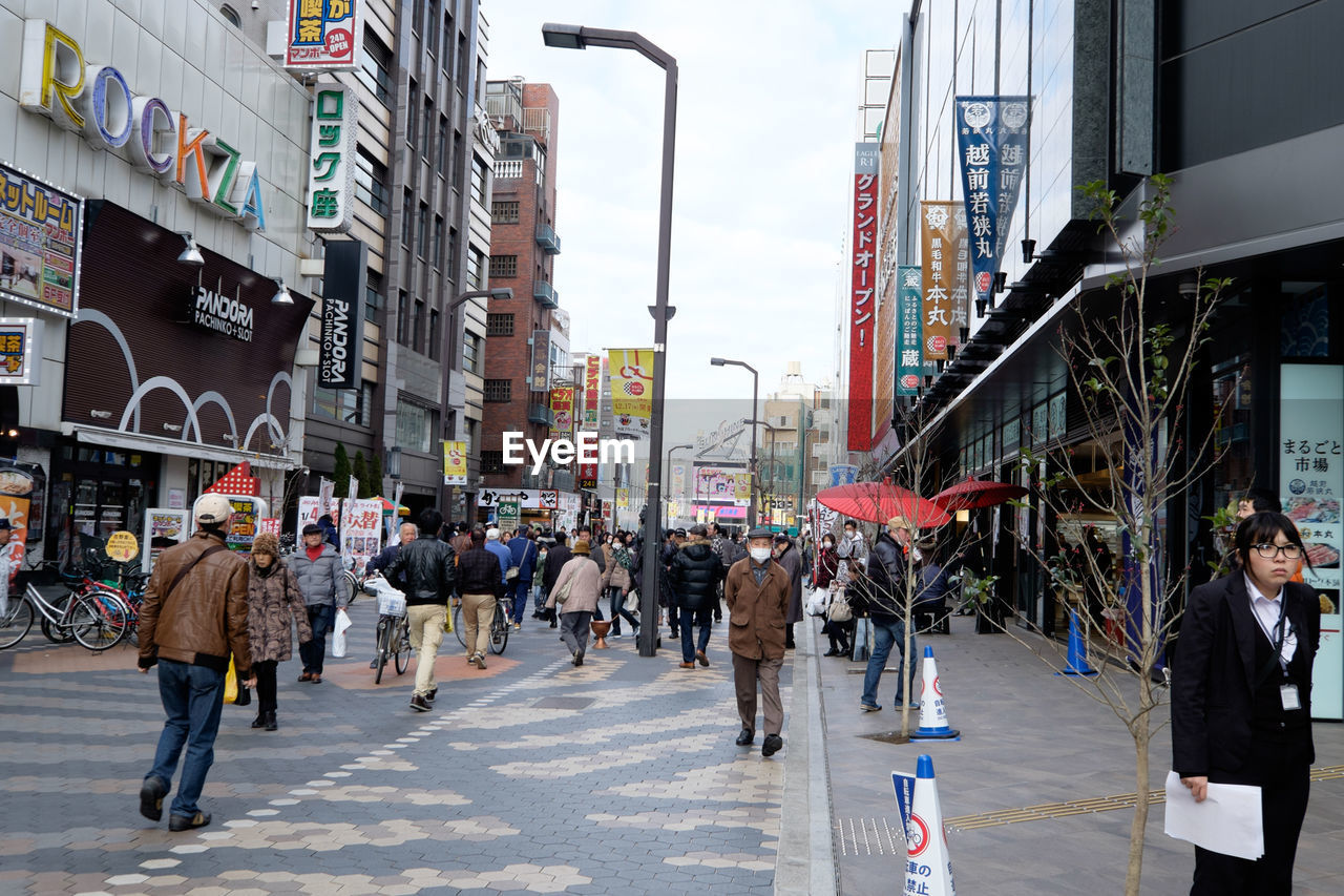 People walking on street amidst buildings