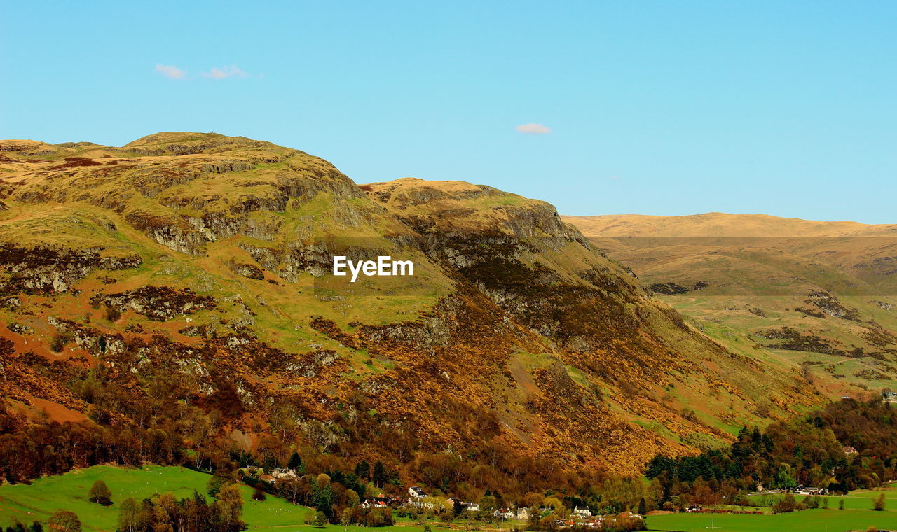 Scenic view of mountains against clear blue sky