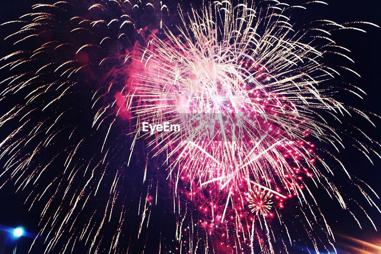 LOW ANGLE VIEW OF FIREWORKS DISPLAY