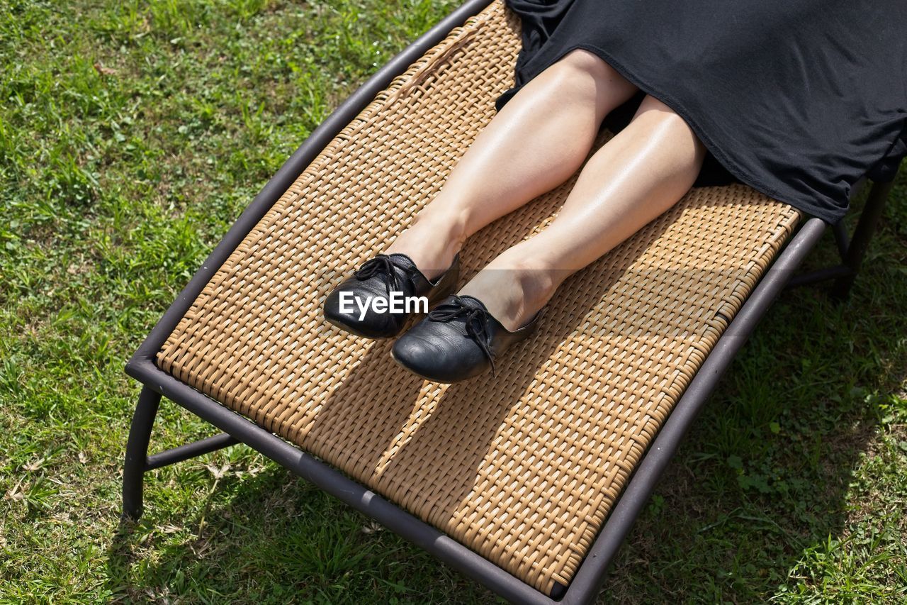 Low section of woman relaxing on seat