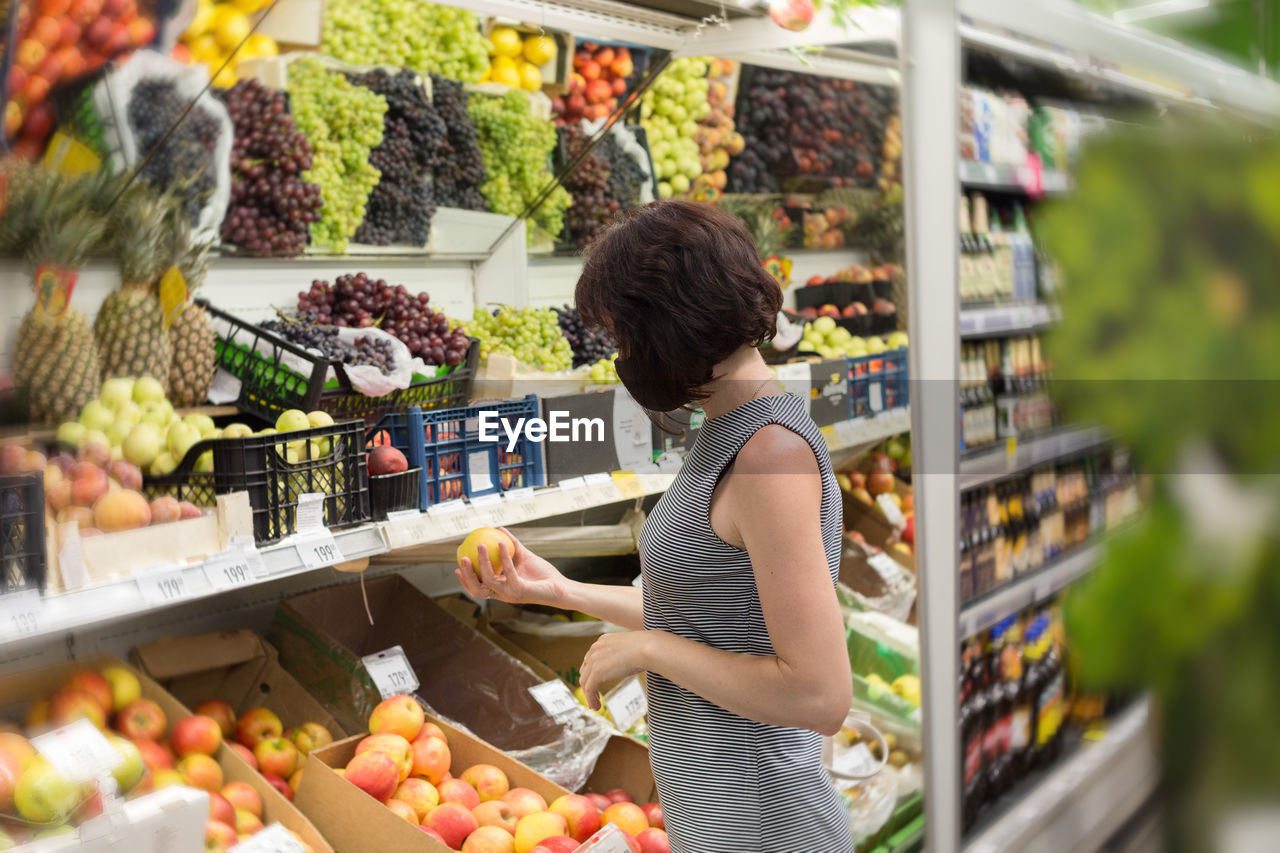 Woman standing at market stall