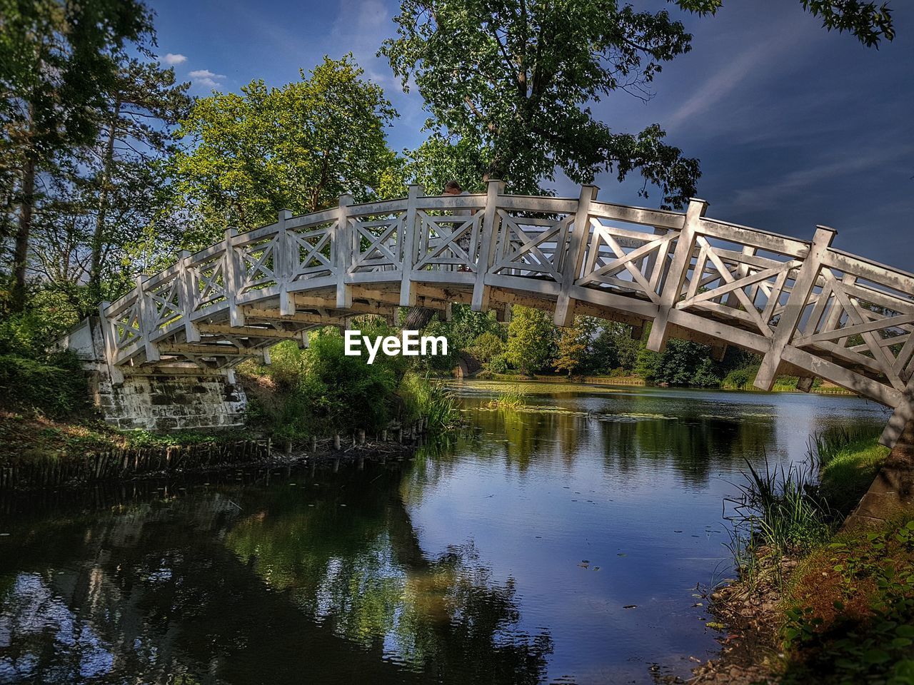 ARCH BRIDGE BY RIVER AGAINST SKY