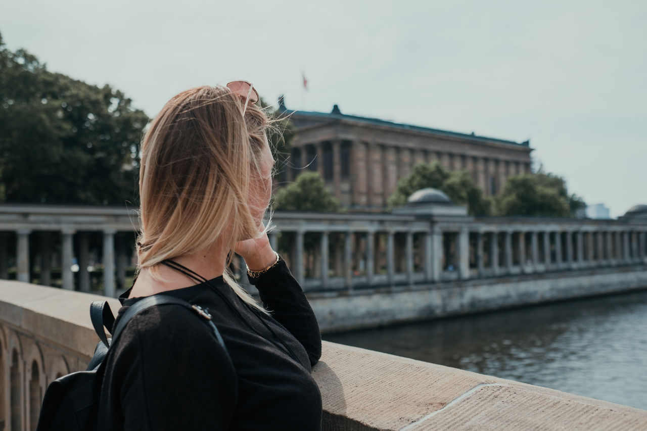 Woman on bridge over canal