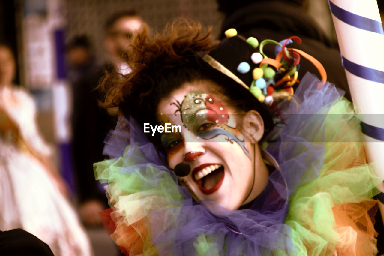 Portrait of happy mid adult woman in face paint standing outdoors