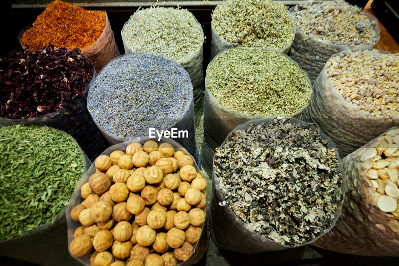 Sacks of dried spices, tea and incense at bazaar market in dubai filling the frame