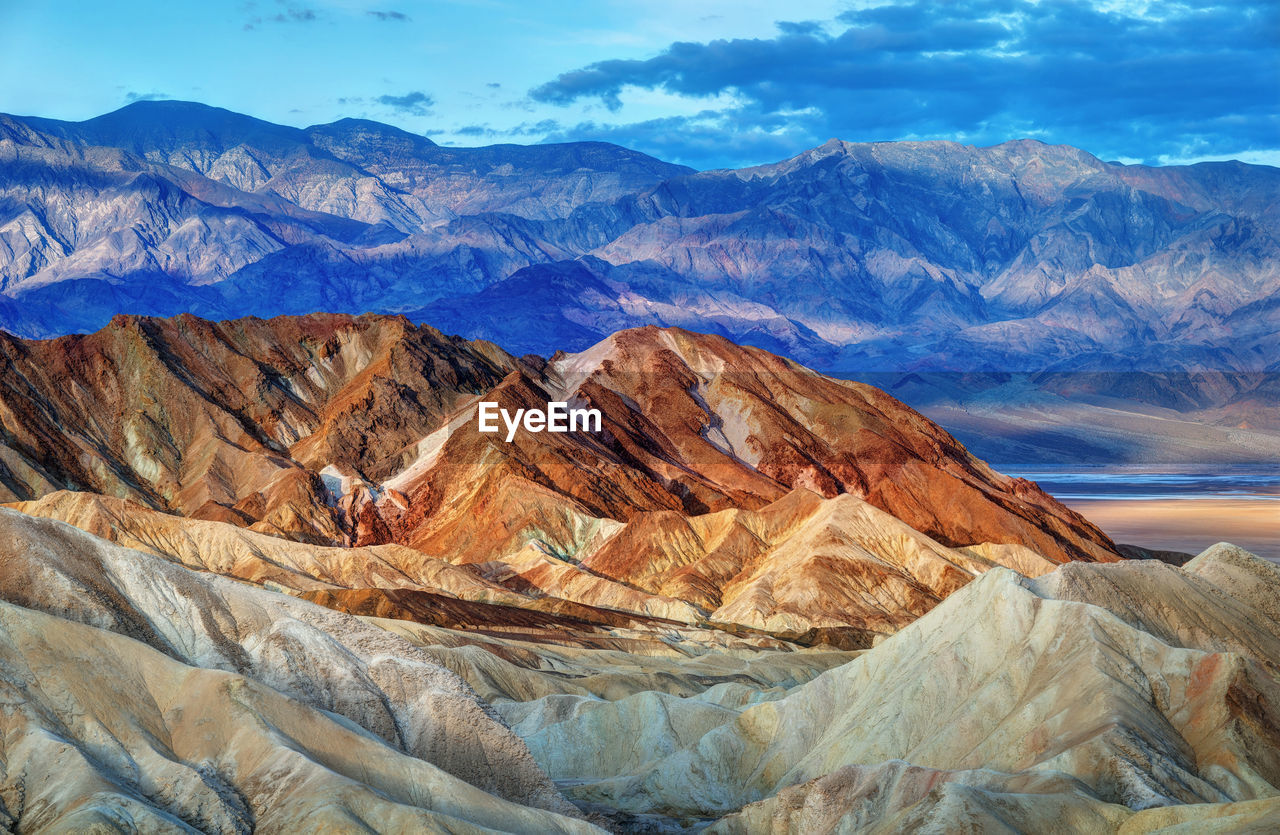 Scenic view of mountains against cloudy sky