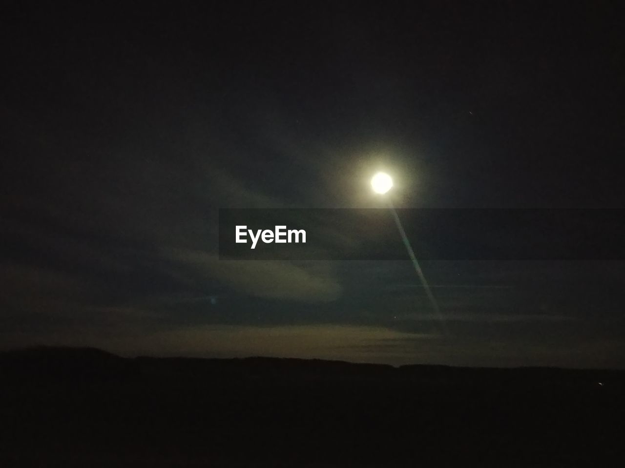 LOW ANGLE VIEW OF SILHOUETTE MOON AGAINST SKY