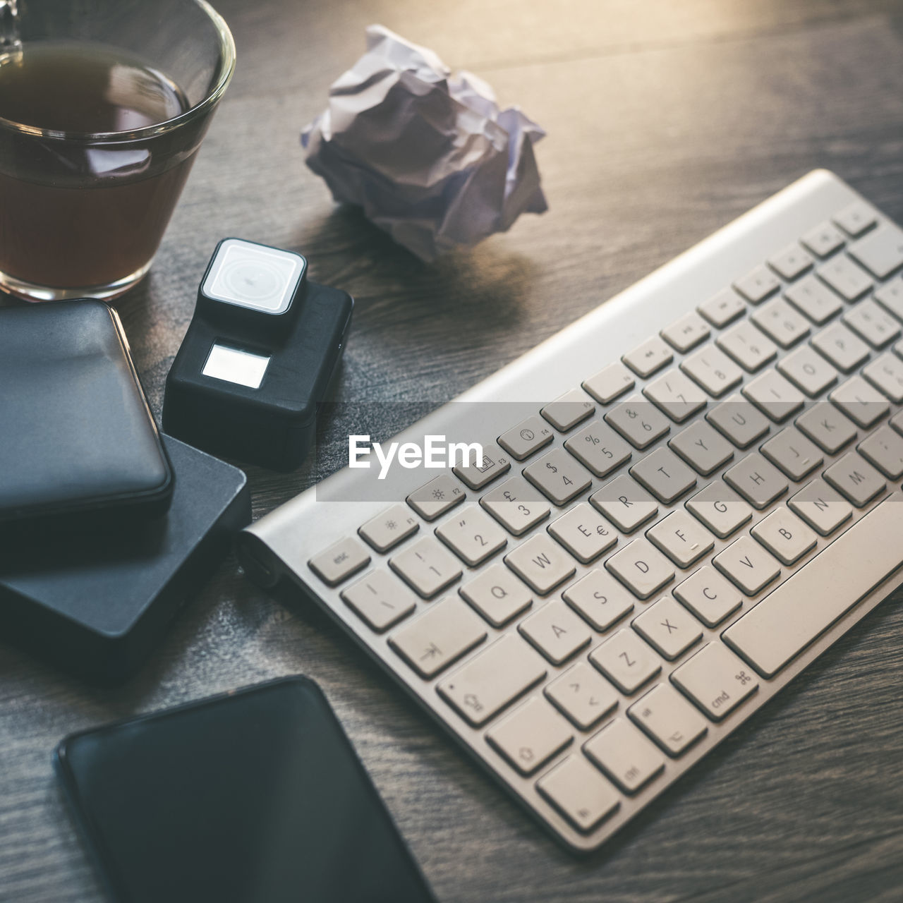 Desktop view with keyboard,  technology devices table with objects for smart working homeschooling 