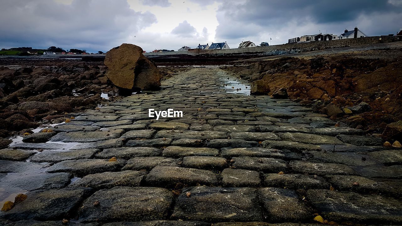 COBBLESTONE STREET AMIDST ROCKS