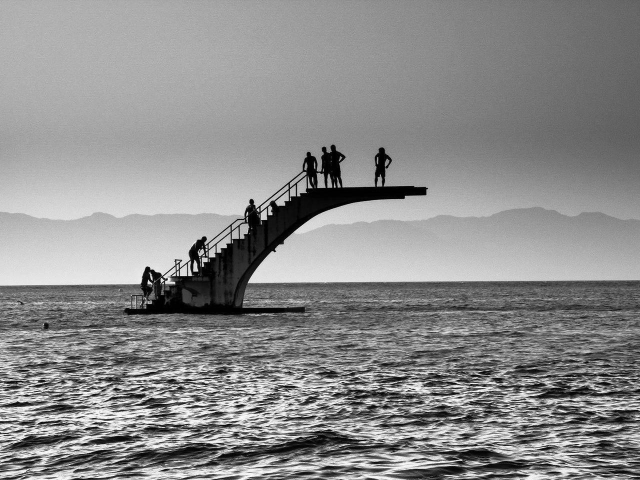 SILHOUETTE OF PEOPLE ON SEA