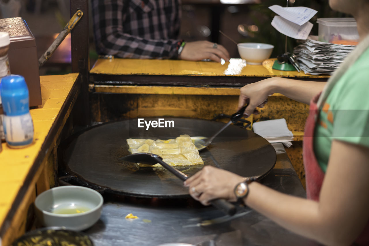 midsection of man preparing food