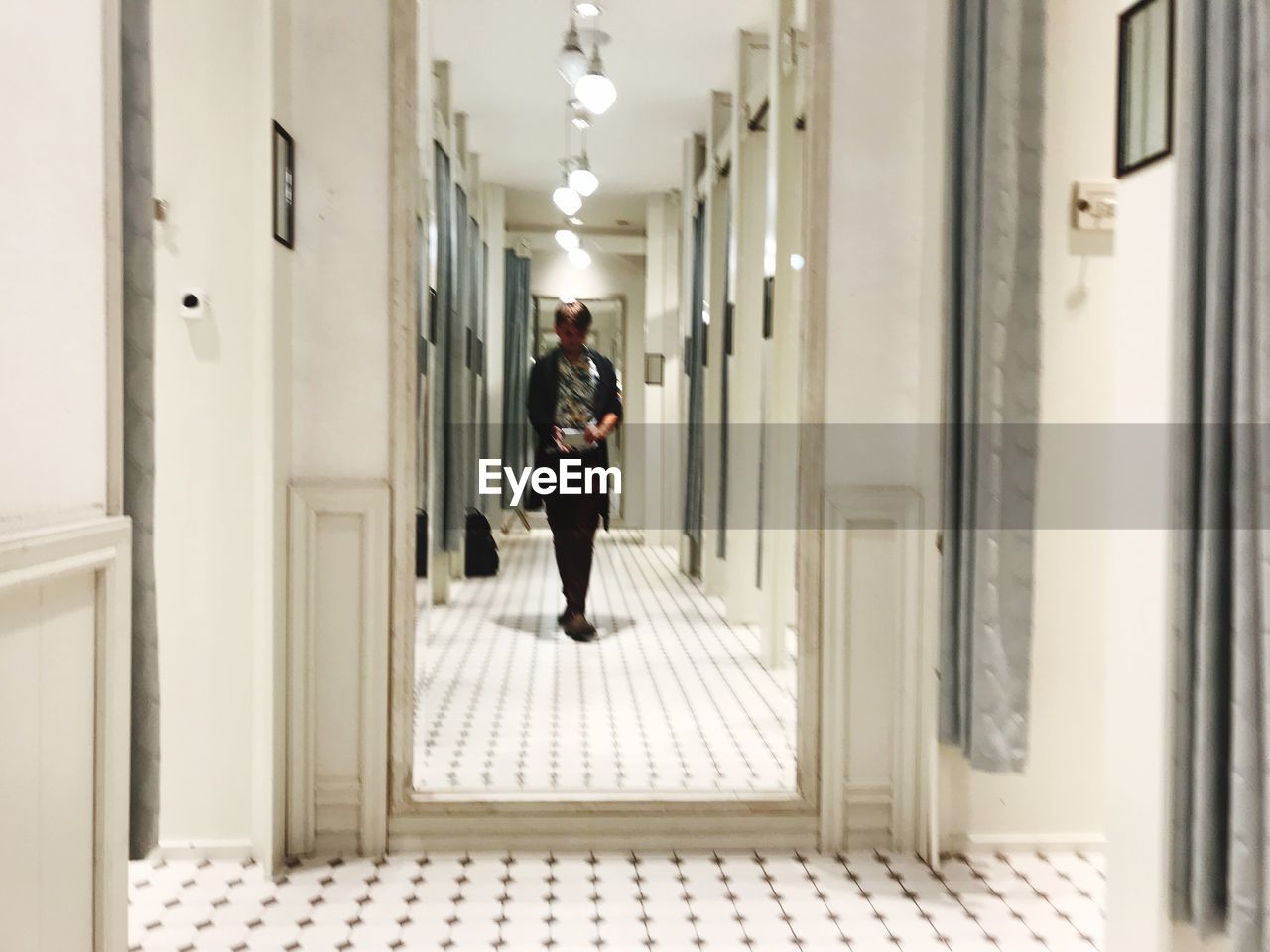 WOMAN WALKING IN CORRIDOR