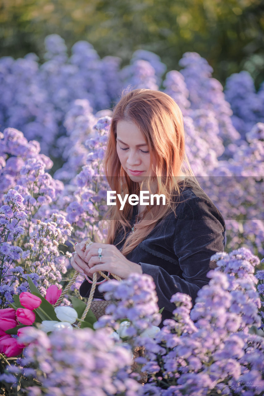 Beautiful woman in flowering plants