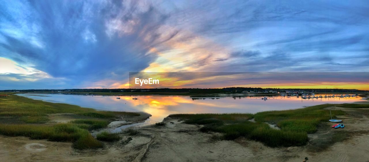 SCENIC VIEW OF BEACH AGAINST SKY AT SUNSET