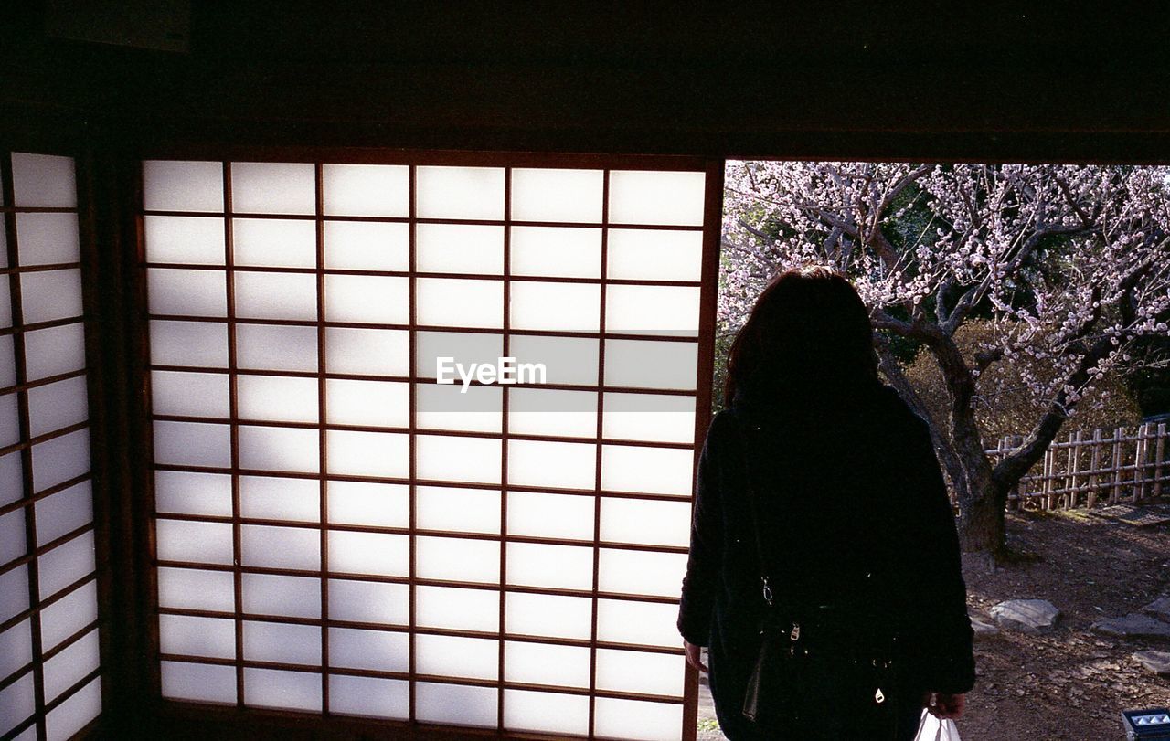 SILHOUETTE OF MAN IN WINDOW