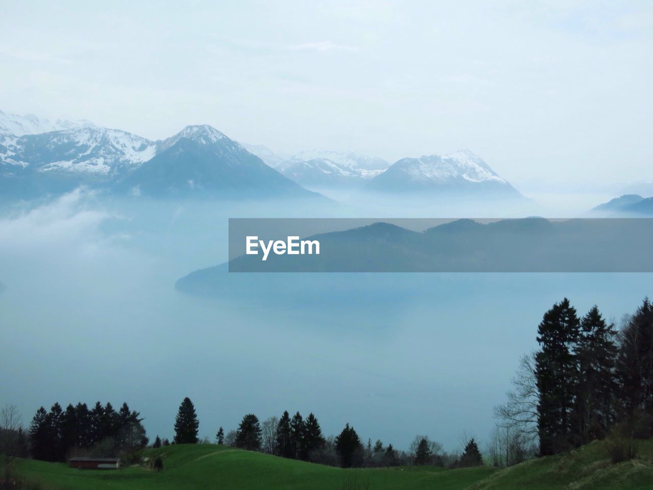 Scenic view of mountains against cloudy sky