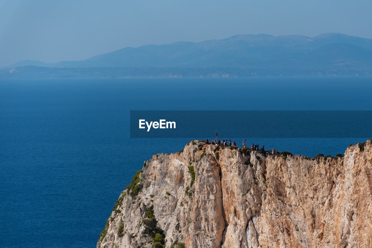 Scenic view of sea and mountains against sky