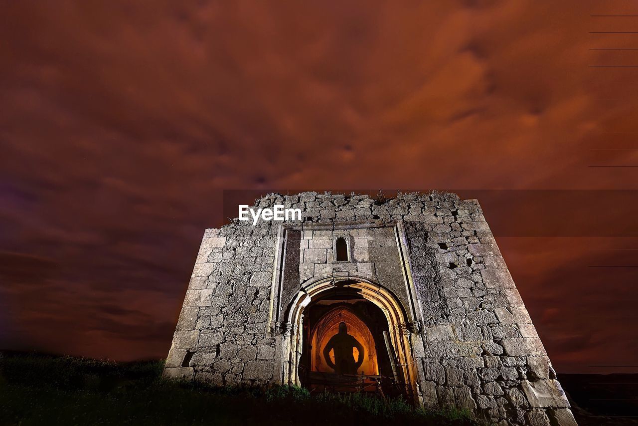 Low angle view of castle against sky at night