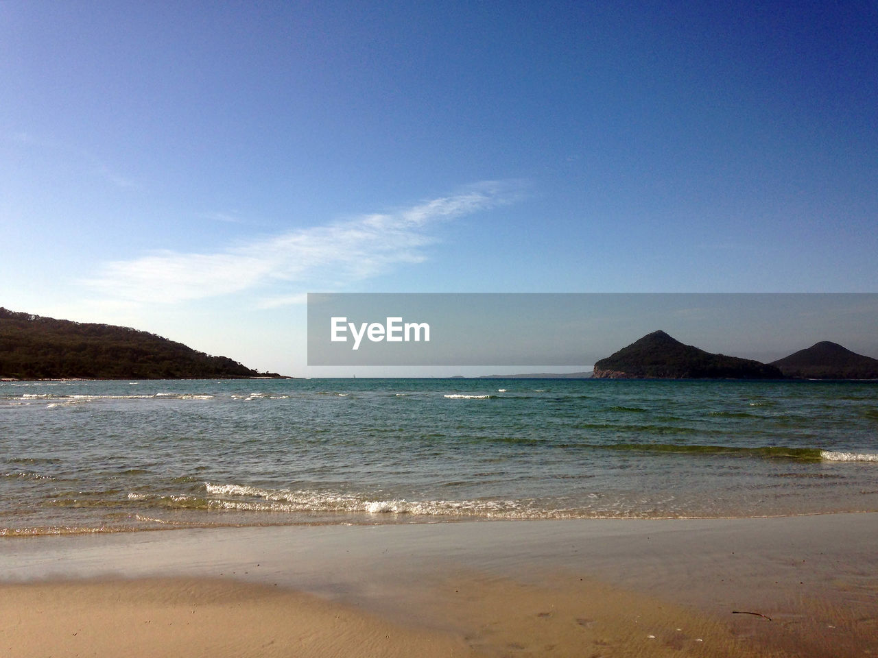 SCENIC VIEW OF BEACH AGAINST BLUE SKY