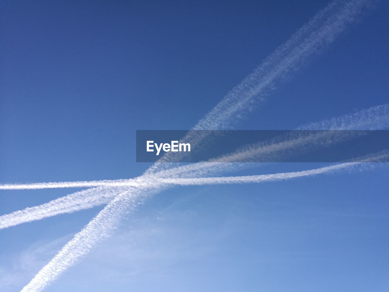 Low angle view of vapor trails in sky