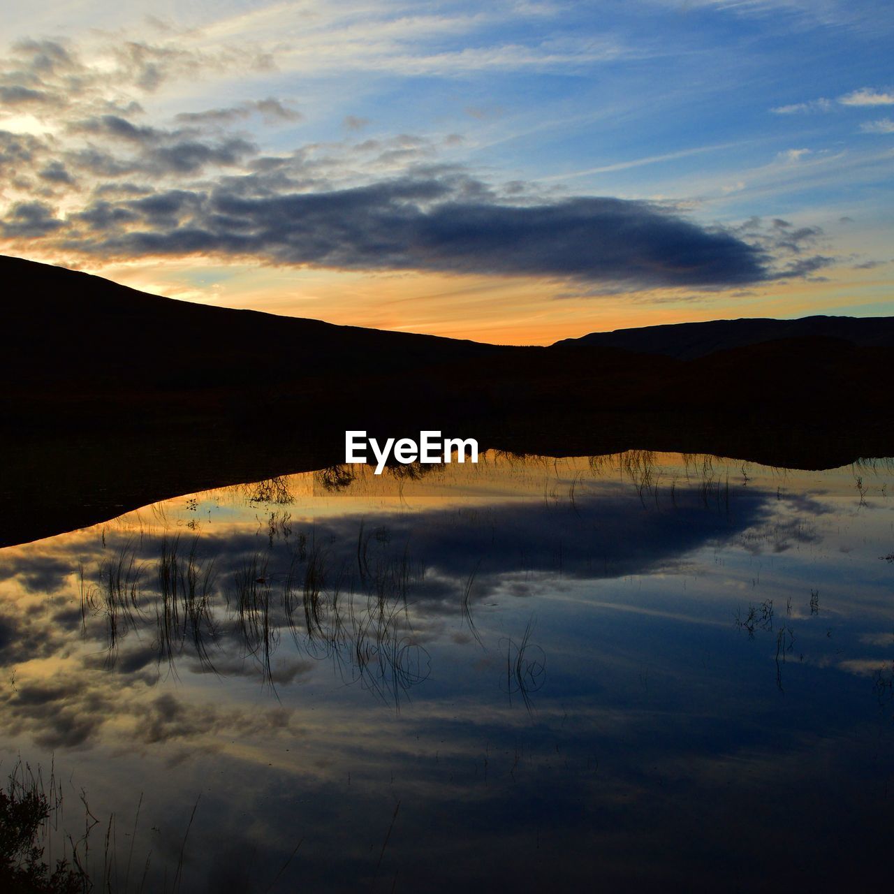 Scenic view of lake at sunset