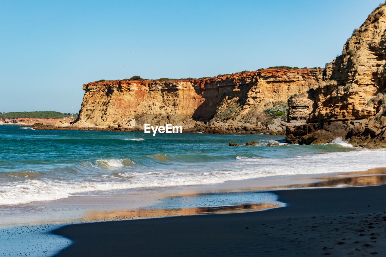 Scenic view of sea against clear blue sky