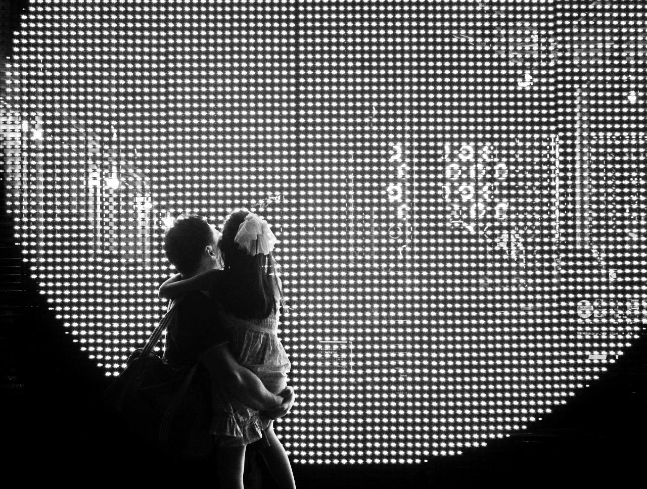 Father with daughter against built structure