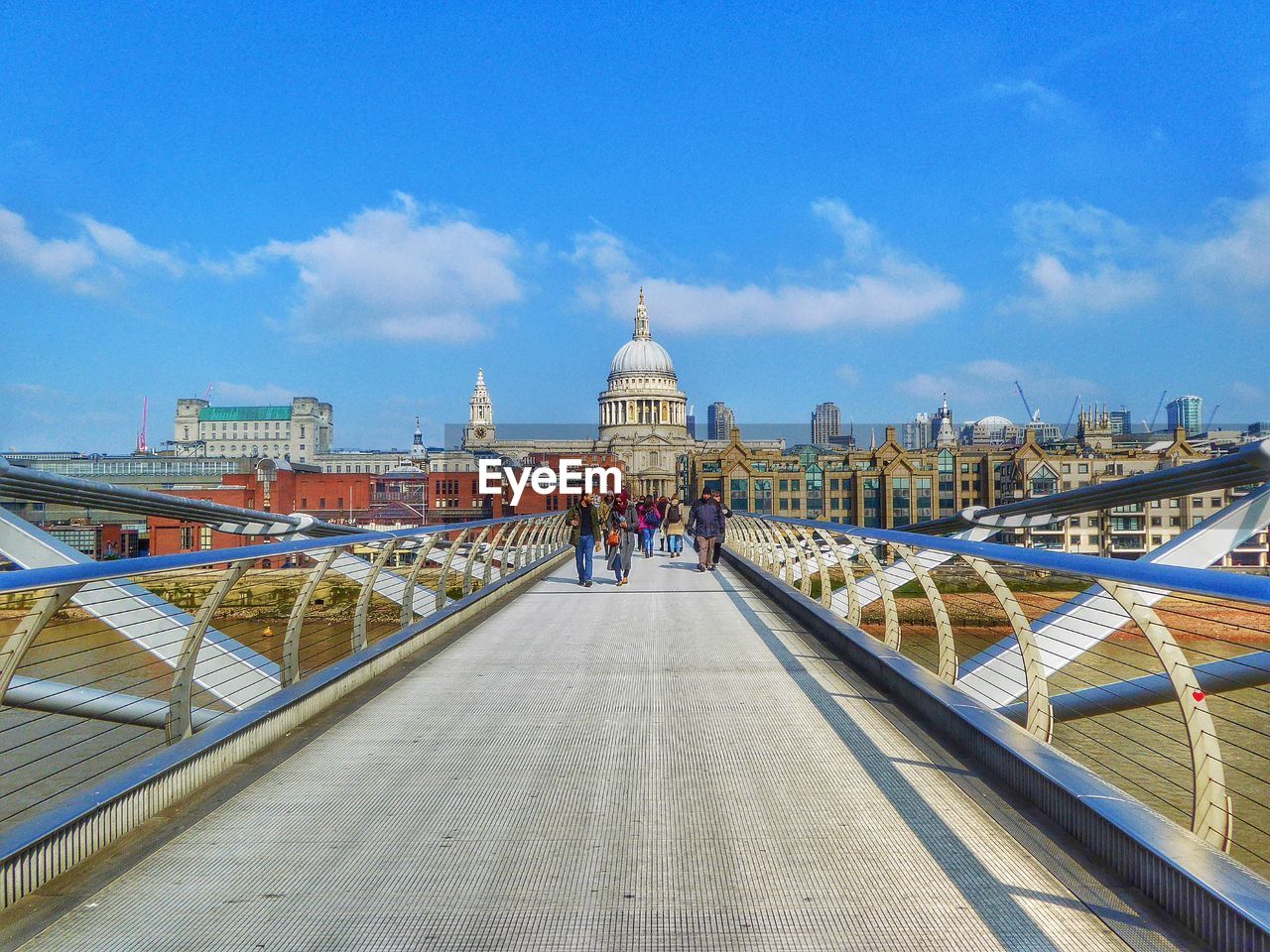 People walking on london millennium footbridge in front of st paul cathedral