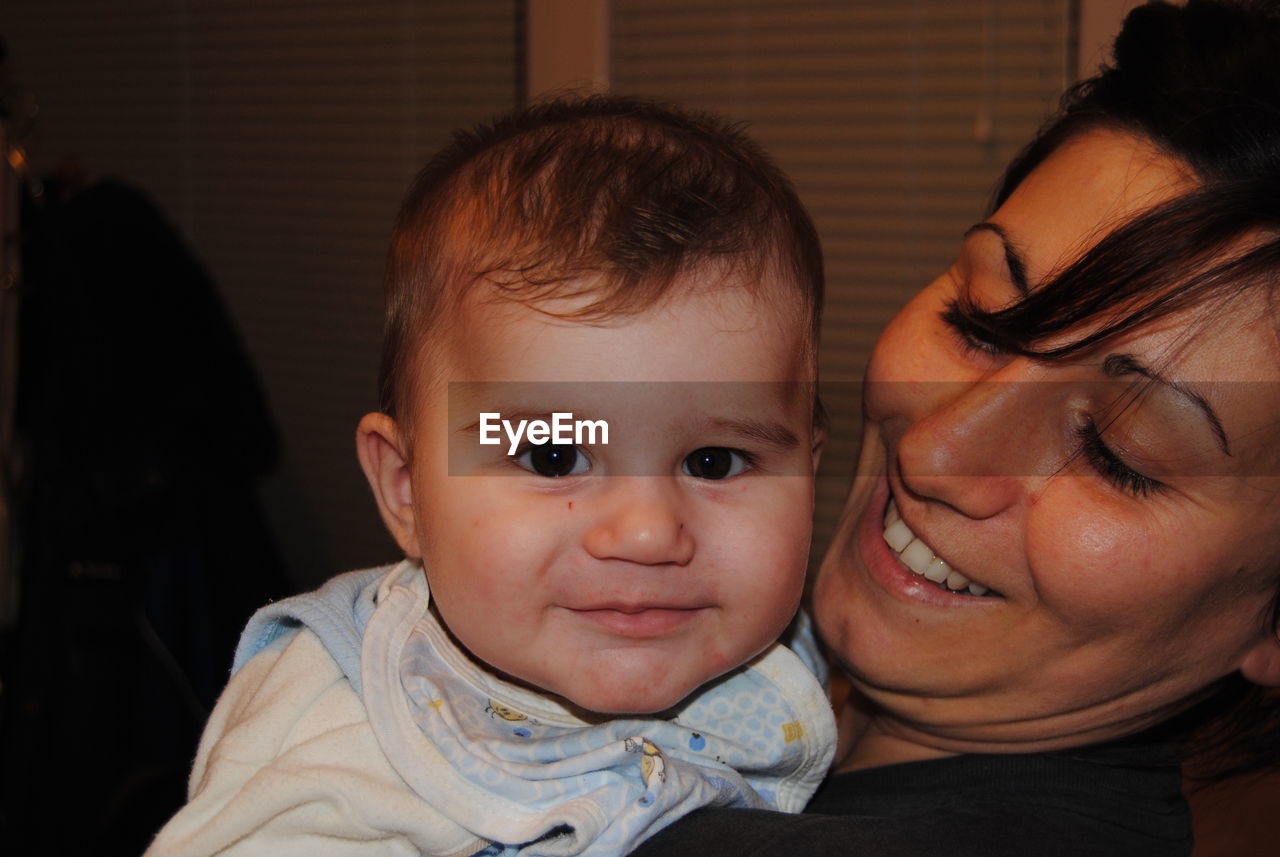 Close-up of mother with baby boy at home