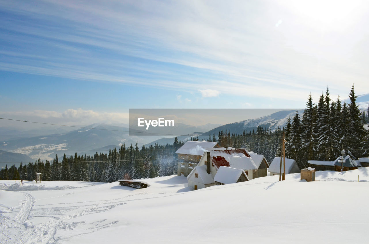panoramic view of snow covered mountains against sky