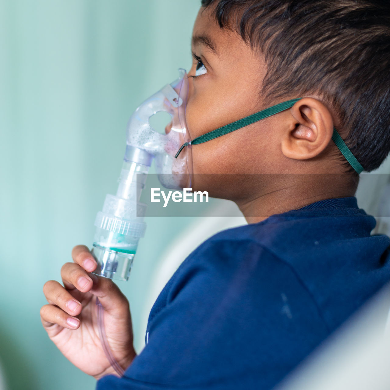 Boy wearing nebulizer at hospital