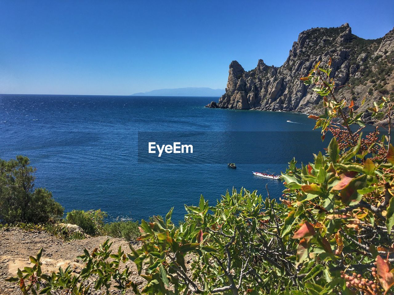 Scenic view of sea against clear blue sky