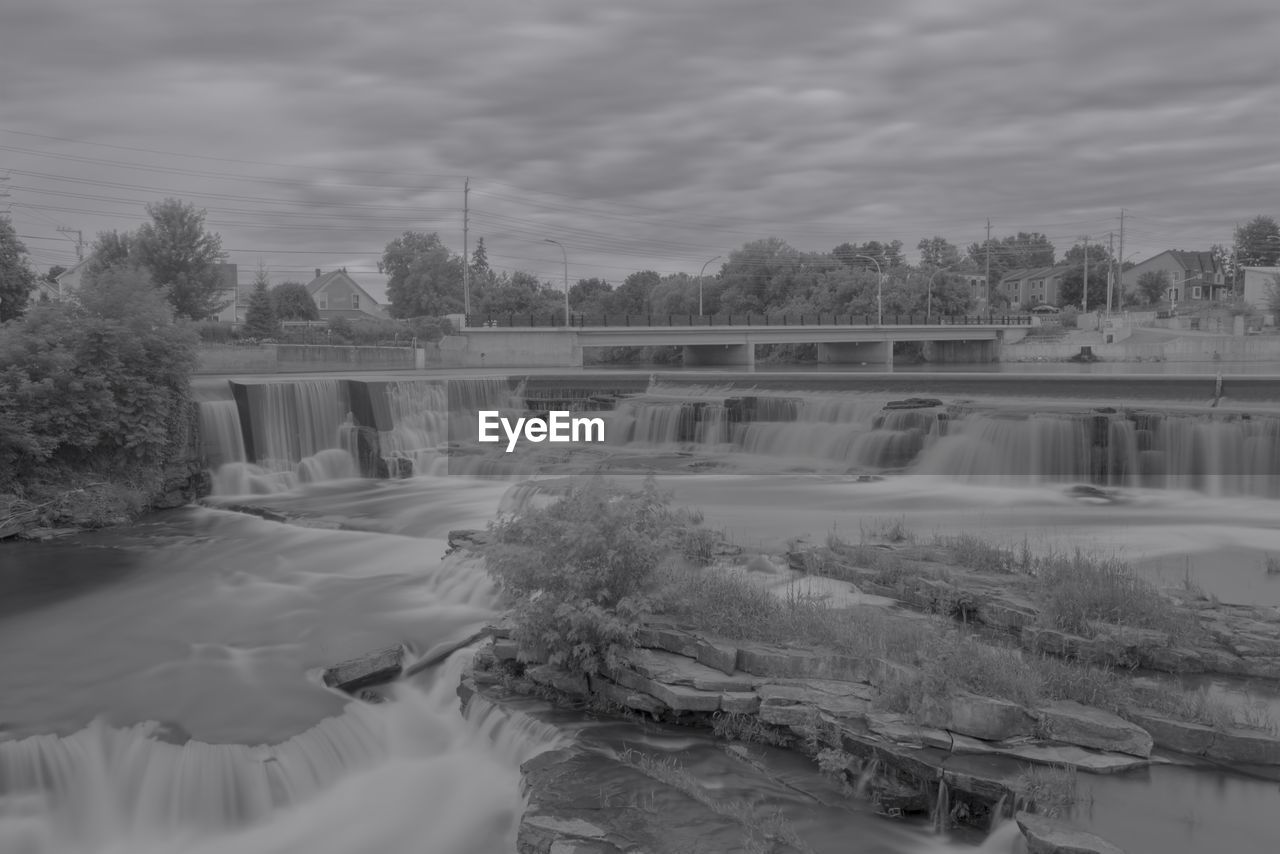 water, winter, black and white, tree, river, nature, monochrome, monochrome photography, snow, architecture, plant, built structure, sky, cloud, waterfall, dam, hydroelectric power, scenics - nature, no people, beauty in nature, environment, day, motion, bridge, long exposure, outdoors, power generation, building exterior, reflection, freezing, flowing water