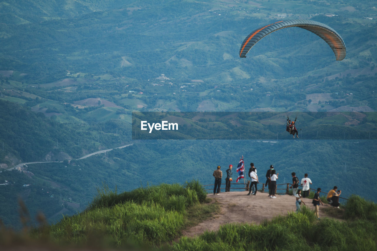 People flying by mountain