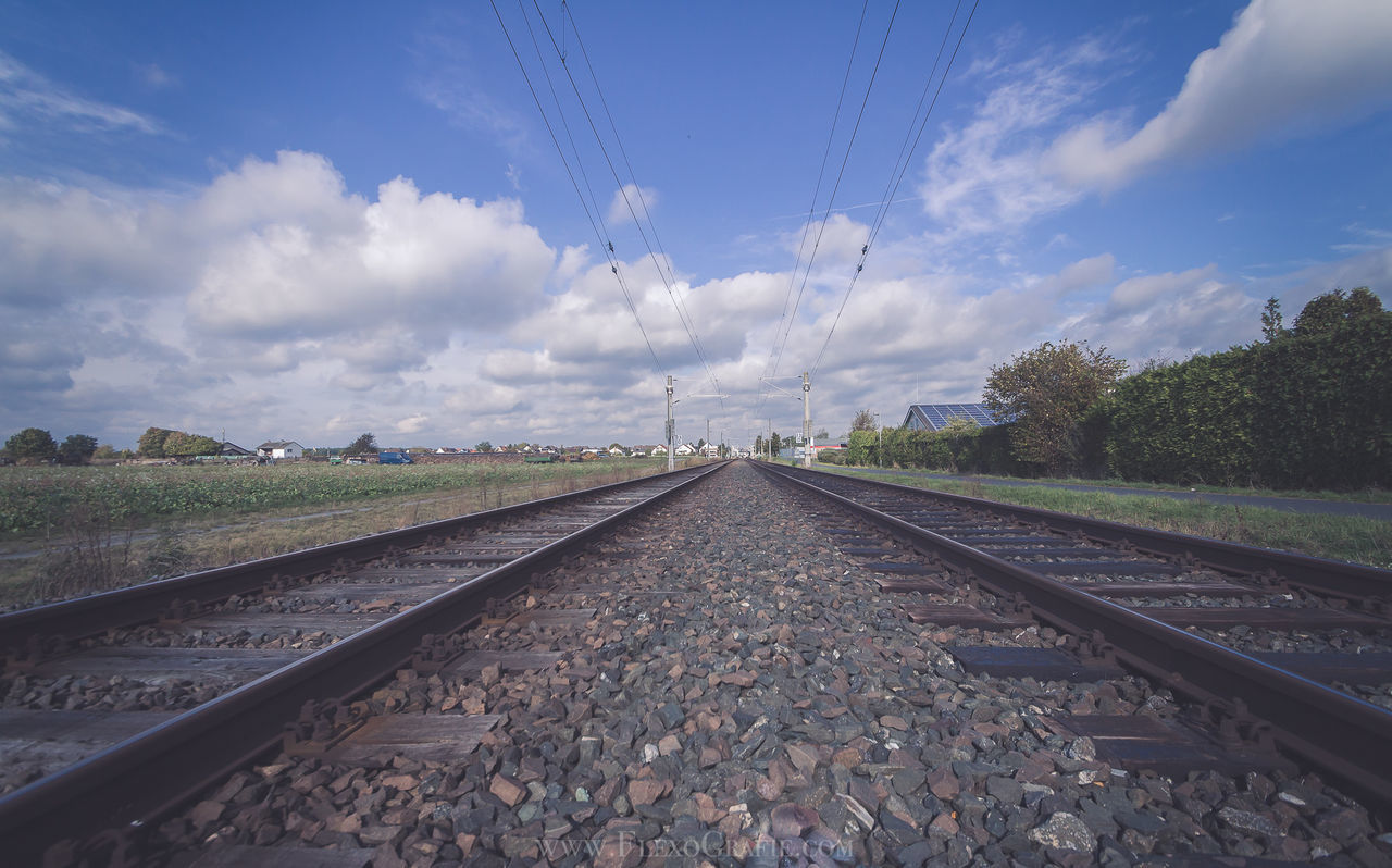 SURFACE LEVEL OF RAILWAY TRACKS AGAINST CLOUDS